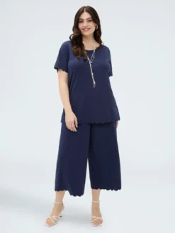 Pantaloni cropped con orlo ricamato