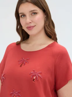 Top con applicazioni paillettes e nodo
