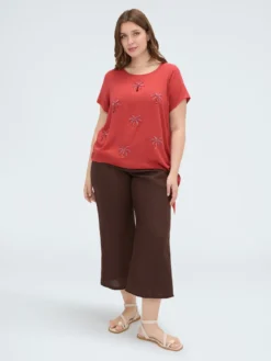 Top con applicazioni paillettes e nodo